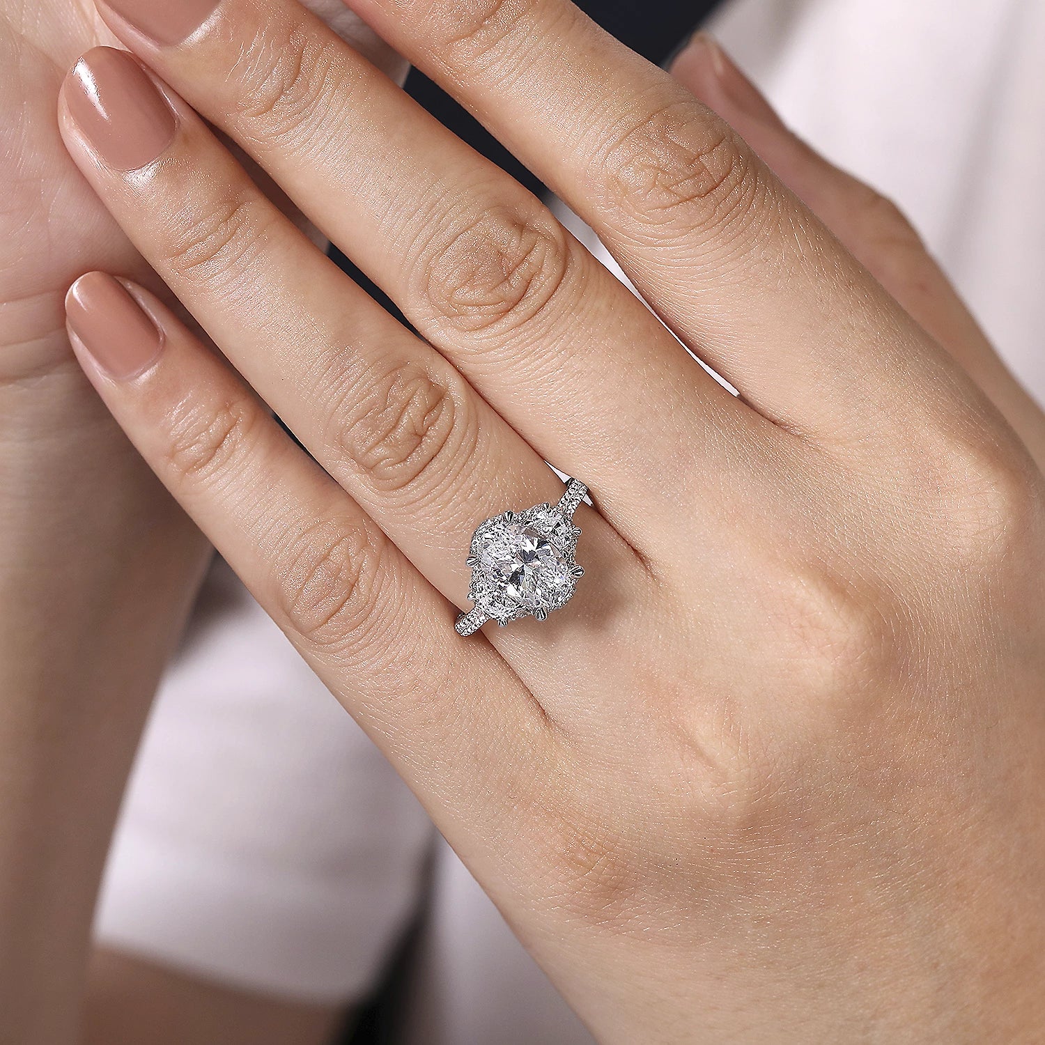 Three stone oval halo 2025 engagement ring